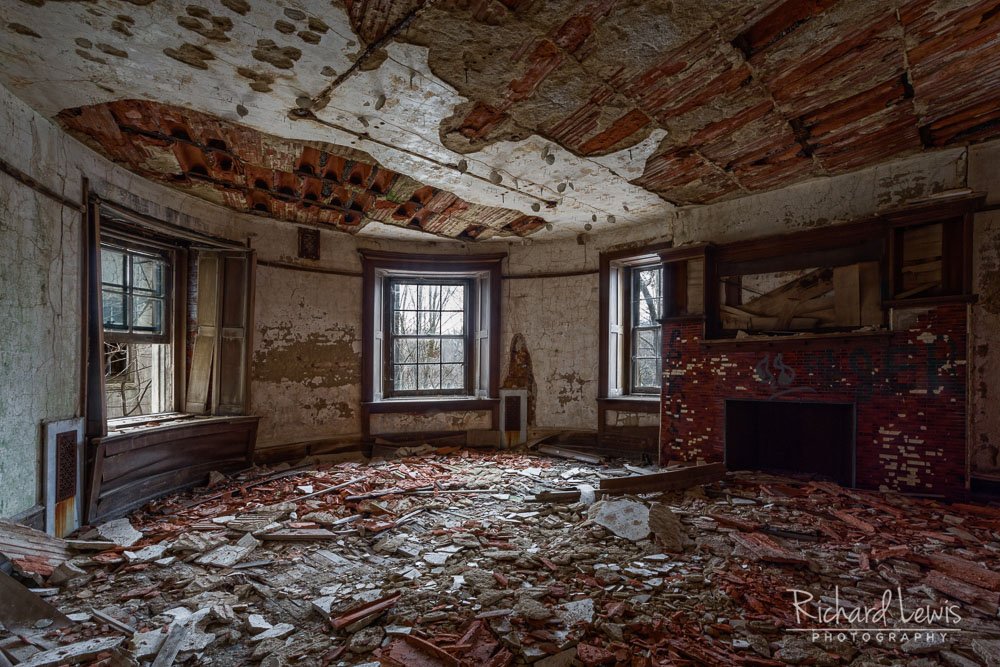 McNeal Mansion interior with fireplace and damaged ceiling — photo by Richard Lewis Photography